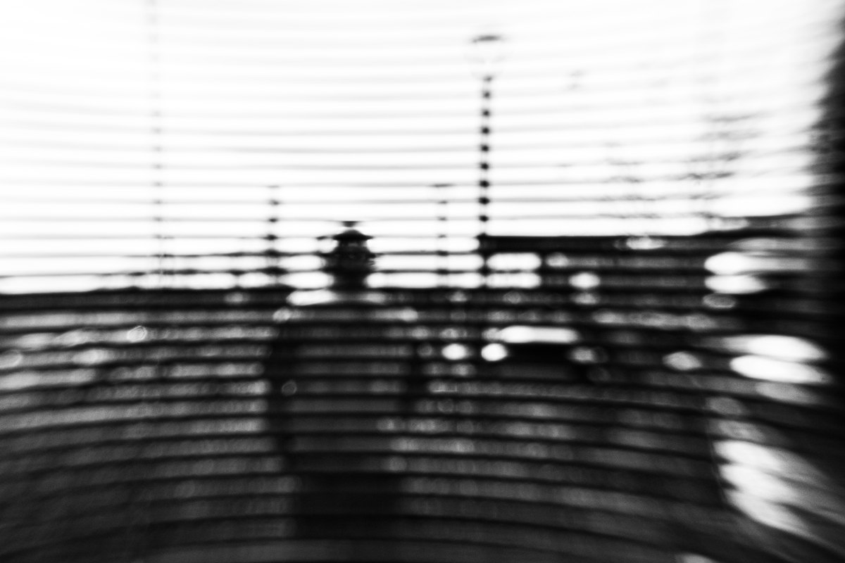 An abstract black-and-white view of construction, with strong horizontal lines and curved shadows.